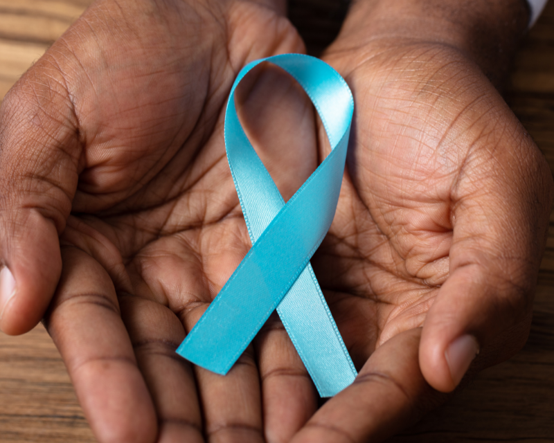 hands holding a teal ribbon